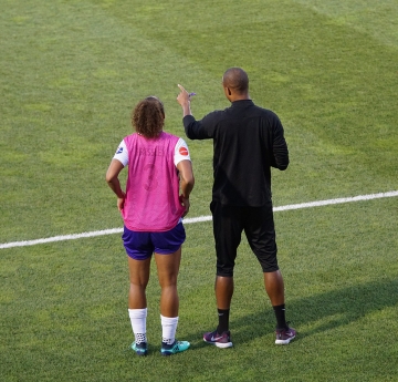 Coach and player on the field