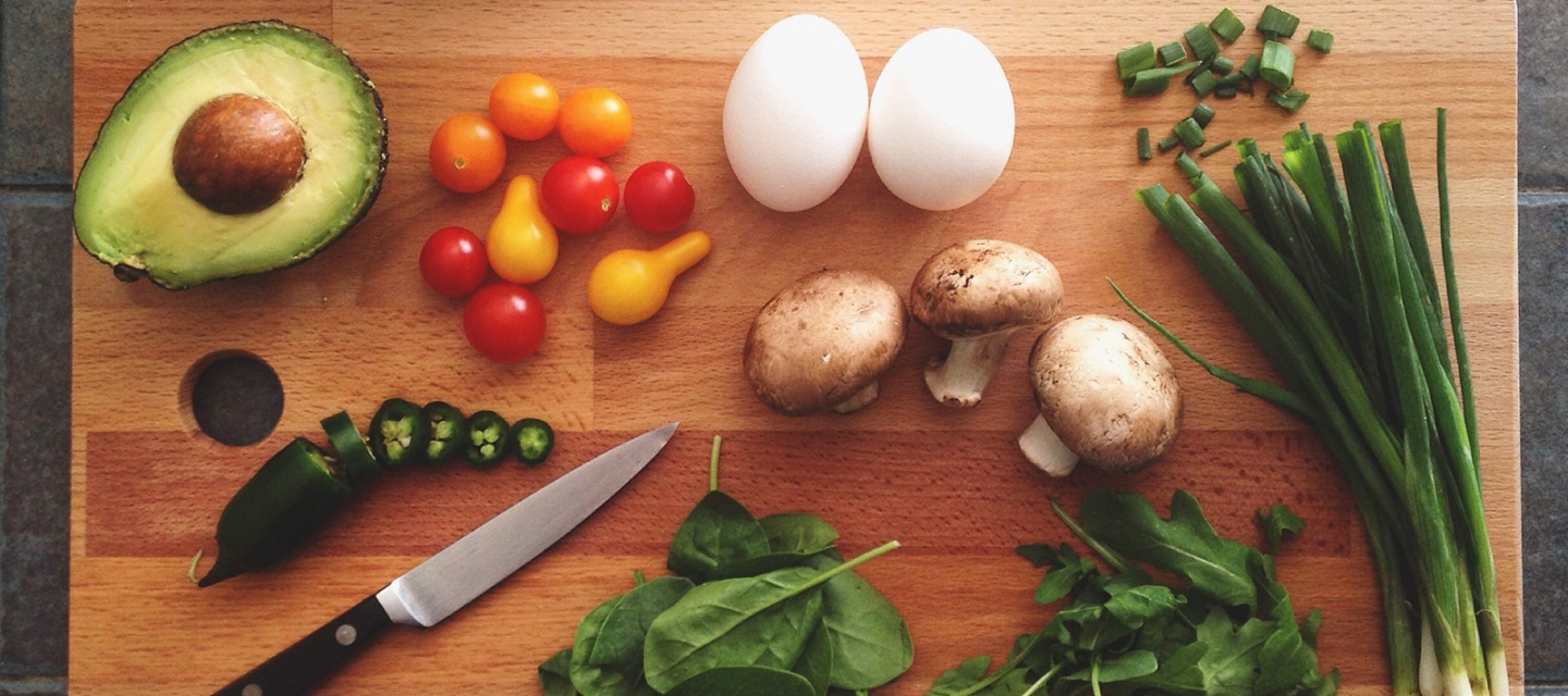 Vegetables and a knife on a cutting board